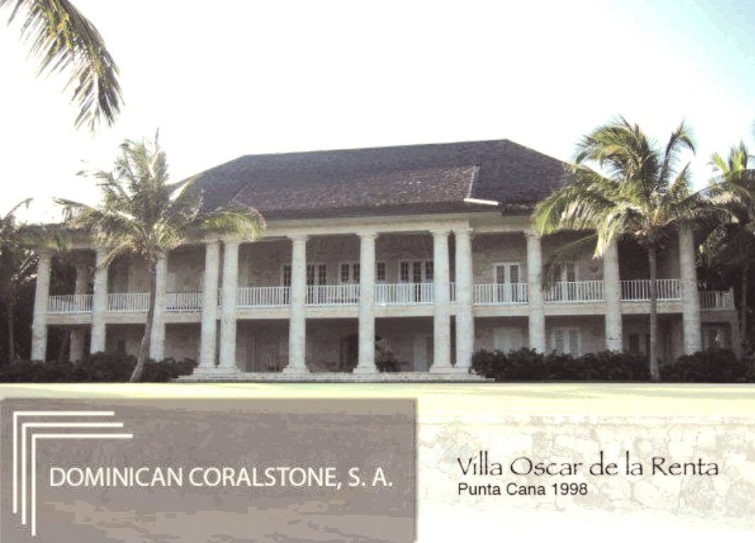 Columned facade of Oscar de la Renta's villa framed by palms, in a Dominican Coralstone archive photograph
