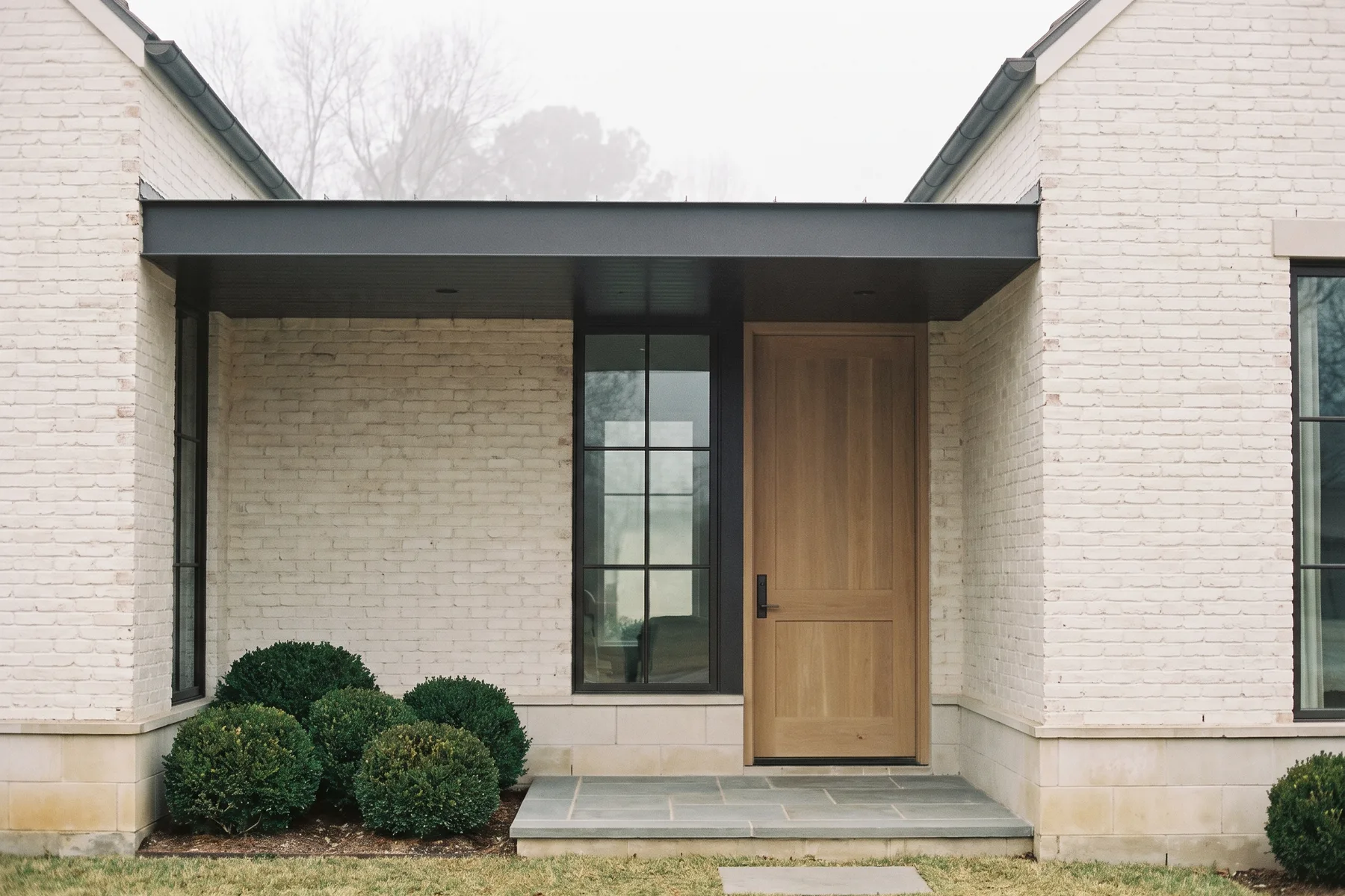 Rendering — The Laurel recessed entry under its flat metal canopy.